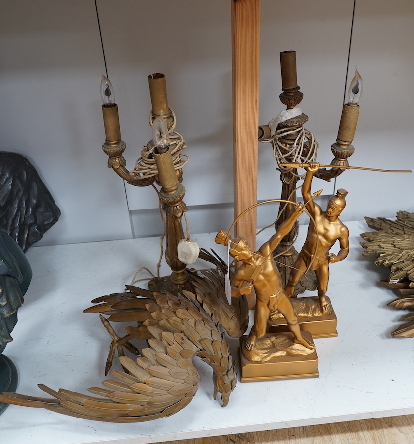 A pair of carved giltwood two branch, three light electric candelabra lamps, a pair of gilt metal Roman warriors and a gilt metal model falcon, lights 51cm high not including light fitting. Condition - lamps poor, warrio